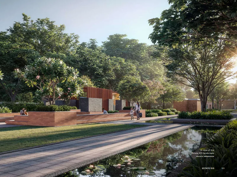 Landscaped garden with walking pathway, water feature, and lush green open spaces at Max Estate 105 Noida