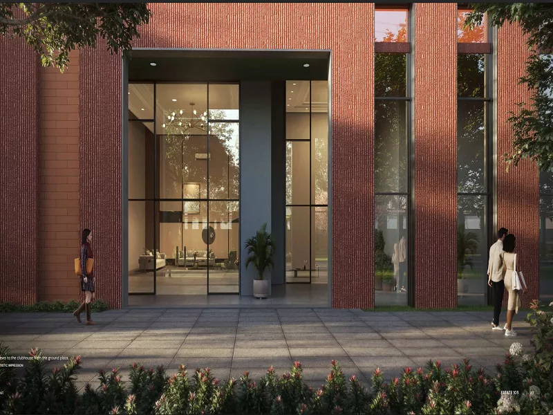 Modern clubhouse entrance with floor-to-ceiling glass facade at Max Estate 105 Noida luxury residential community